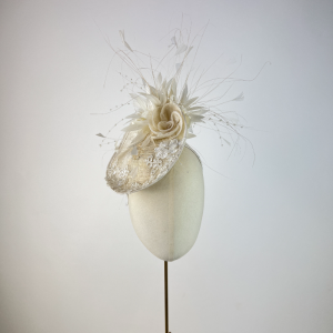 ivory lace saucer hat / fascinator with feathers and flowers on the underneath