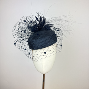 Navy blue pillbox hat with veil and feathers, classic elegant style
